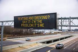 A message sign on highway in Arizona that cites a Taylor Swift line- "Say It: I'm the Problem, It's Me" (texting and driving)