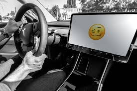 touchscreens can be dangerous in cars. Here is an emoji of an unhappy face on the touchscreen.