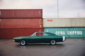 an older car and a shipping container.