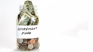 A picture of a jam jar filled with dollar bills and the label on it says "retirement fund." This is a stock image for an AARP program called mysavingsjar